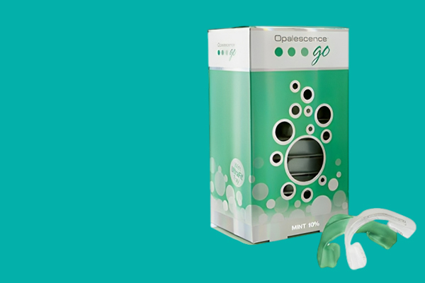 Opalescence Go teeth whitening kit box with mint flavor applicator on turquoise background.